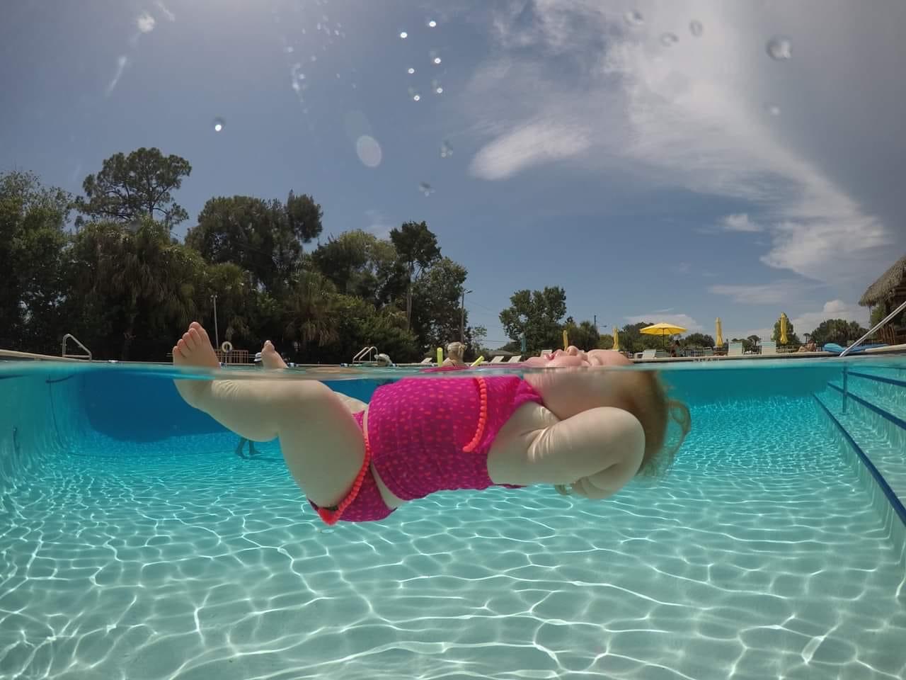 Child learning ISR survival swim skills in Redding CA pool